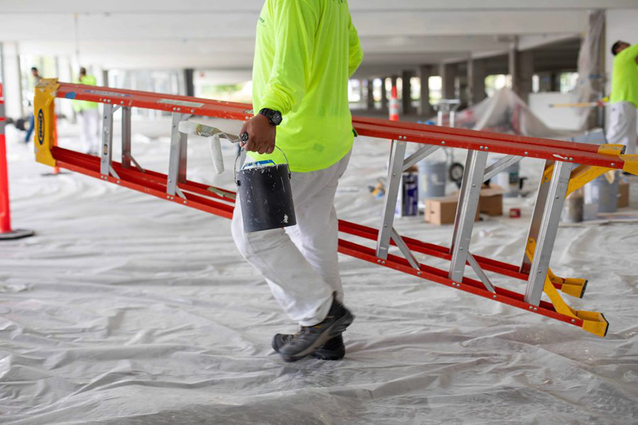 Connor Painting Employee with Ladder and Paint Bucket